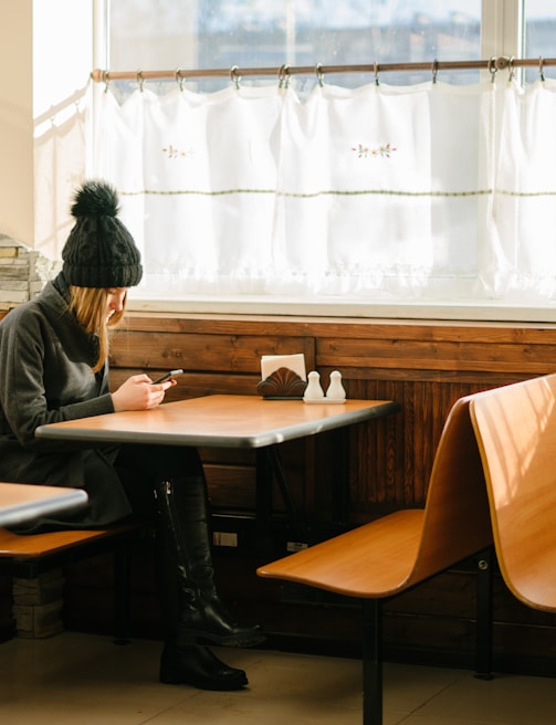 person sitting in front of brown wooden table