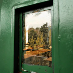 View from the window showing the olive green accents of the Ethimo restaurant’s outdoor seating.
