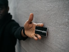 person holding black name plate