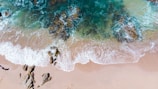 photo of sea waves crushing rocks