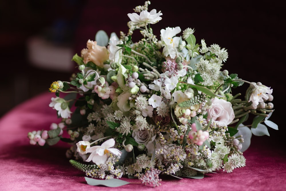 photo of bouquet flowers on pink cushion