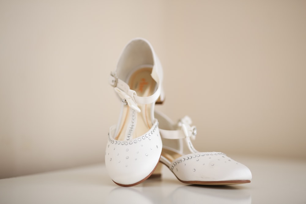pair of women's white kitten heels