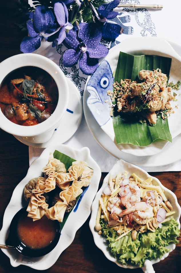 Ceramic plates with dishes on table 