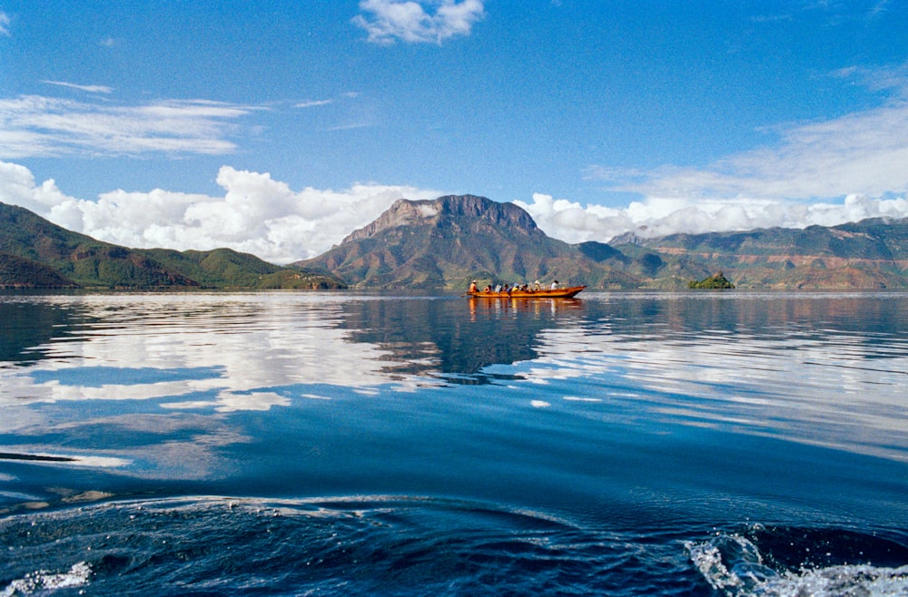 group of people riding on boat at body of water