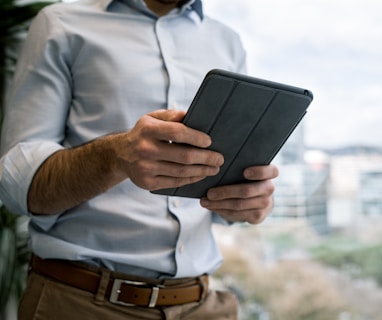 person holding black smart cover during daytime