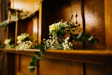 A beautifully arranged shelf showcasing crochet flowers and handmade decorations.