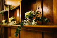 A rustic wooden shelf adorned with vintage books and delicate glass vases.