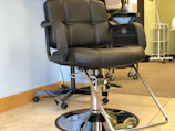 Close-up of smart salon chair with digital controls in tonisavio studio.