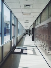 A clean, well-maintained school hallway with shiny floors and bright lighting.
