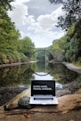 silver MacBook Pro on brown wood log