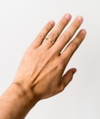 Hypoallergenic rings stacked on a hand with natural skin tones.
