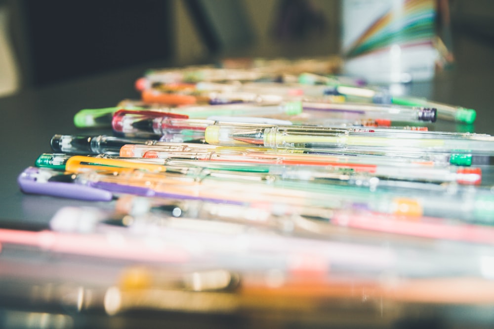 assorted-color pen on table