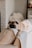 fawn pug lying on gray blanket