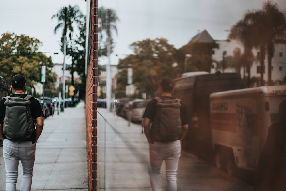 man walking with backpack photography