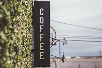 coffee signage beside bicycle