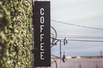 coffee signage beside bicycle