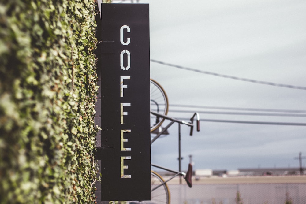 coffee signage beside bicycle