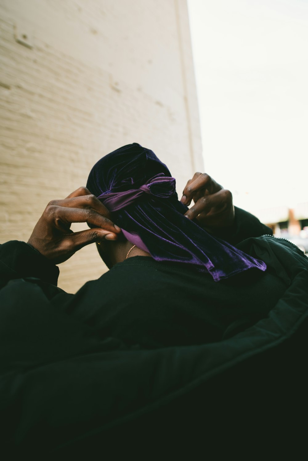 person putting on purple headdress