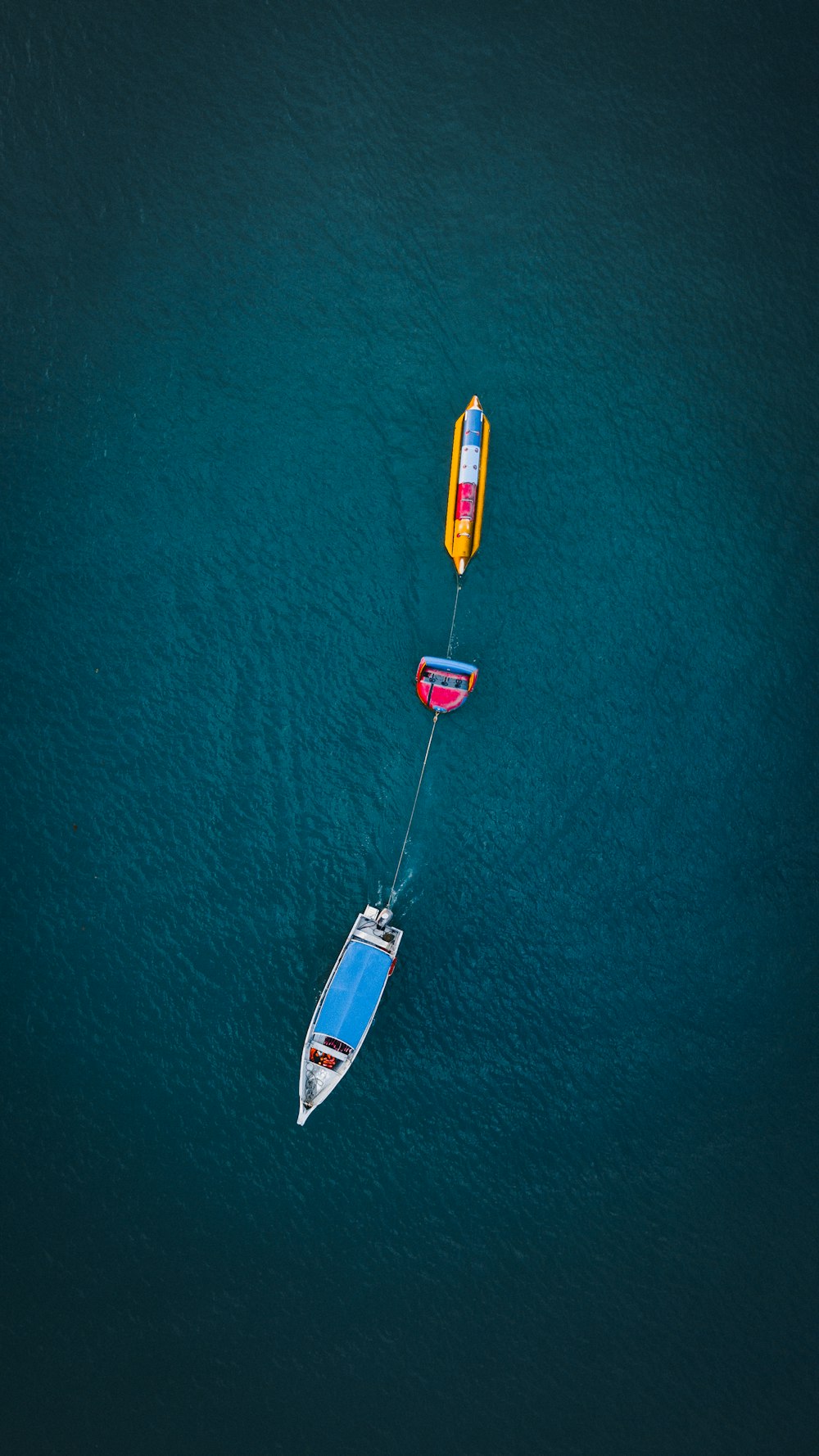 white and yellow boats on body of water