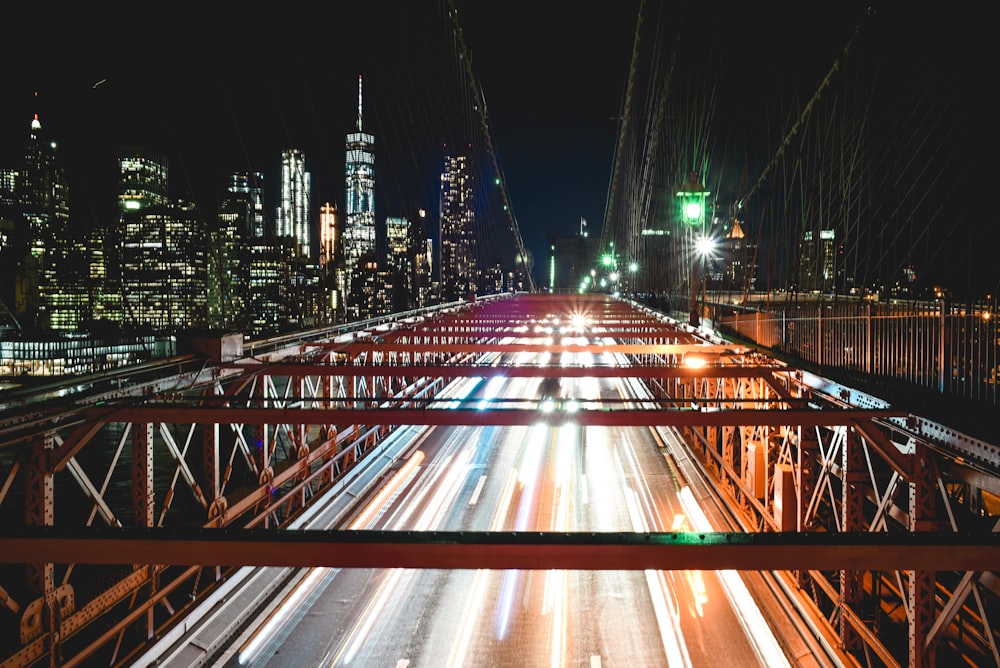 time lapse photography of moving vehicles on bridge