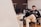 man smiling while sitting and using MacBook