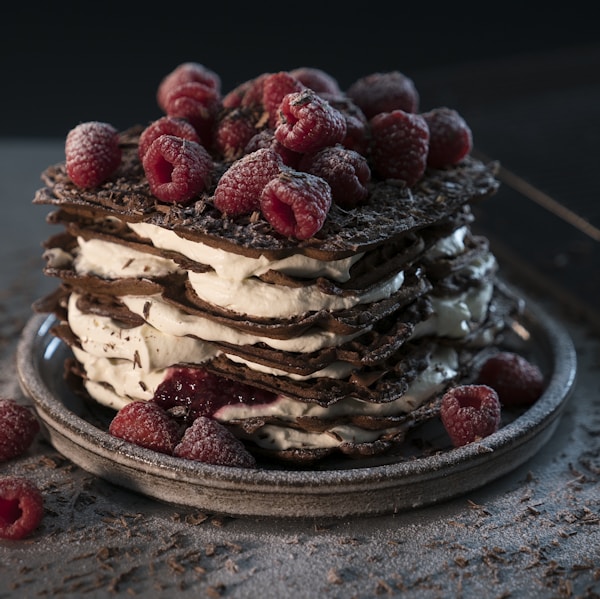 red raspberries on chocolate and cream cake