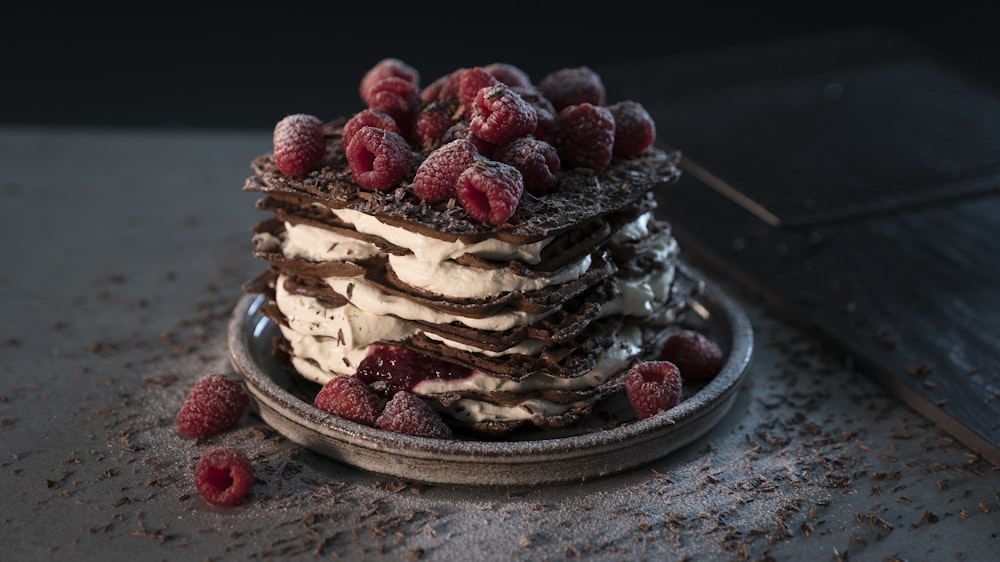 red raspberries on chocolate and cream cake