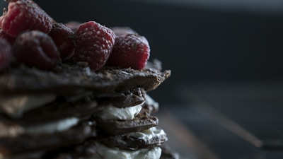 Close-up of a creamy chocolate mousse topped with fresh raspberries