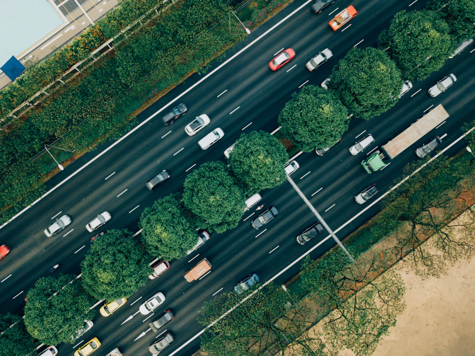 Busy highway with multiple lanes filled with cars moving in both directions overhead