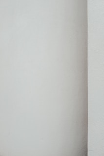 Smooth plastered wall with a fresh coat of paint highlighting clean lines.