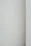 Close-up of smooth, freshly applied plaster on a wall corner in soft natural light.