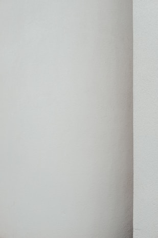 Smooth plastered wall with a fresh coat of paint highlighting clean lines.