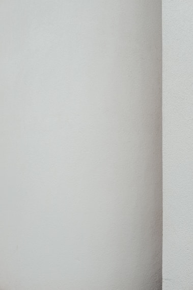 Close-up of a freshly painted, smooth wall with a subtle sheen showcasing professional brushwork.