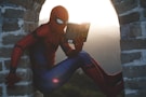 Spider-Man leaning on concrete brick while reading book