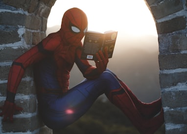 Spider-Man leaning on concrete brick windowsill while reading book