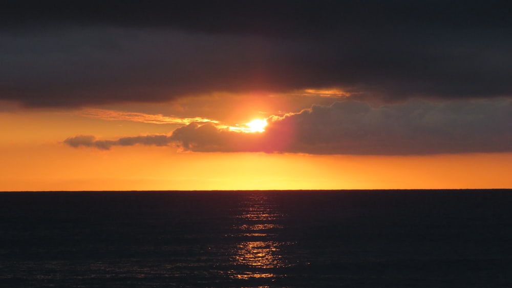 calm body of ocean during golden hour