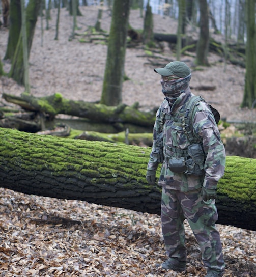 man standing on dried leaves during daytime