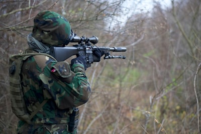 person holding assault rifle army teams background