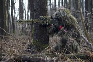person holding green rifle shooting