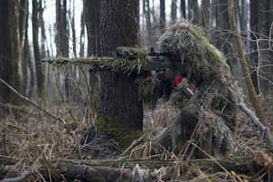 person holding green rifle shooting
