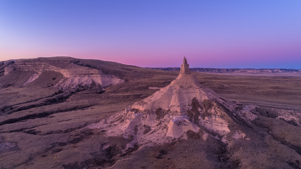 aerial photography of brown rock formations under blue sky at daytime