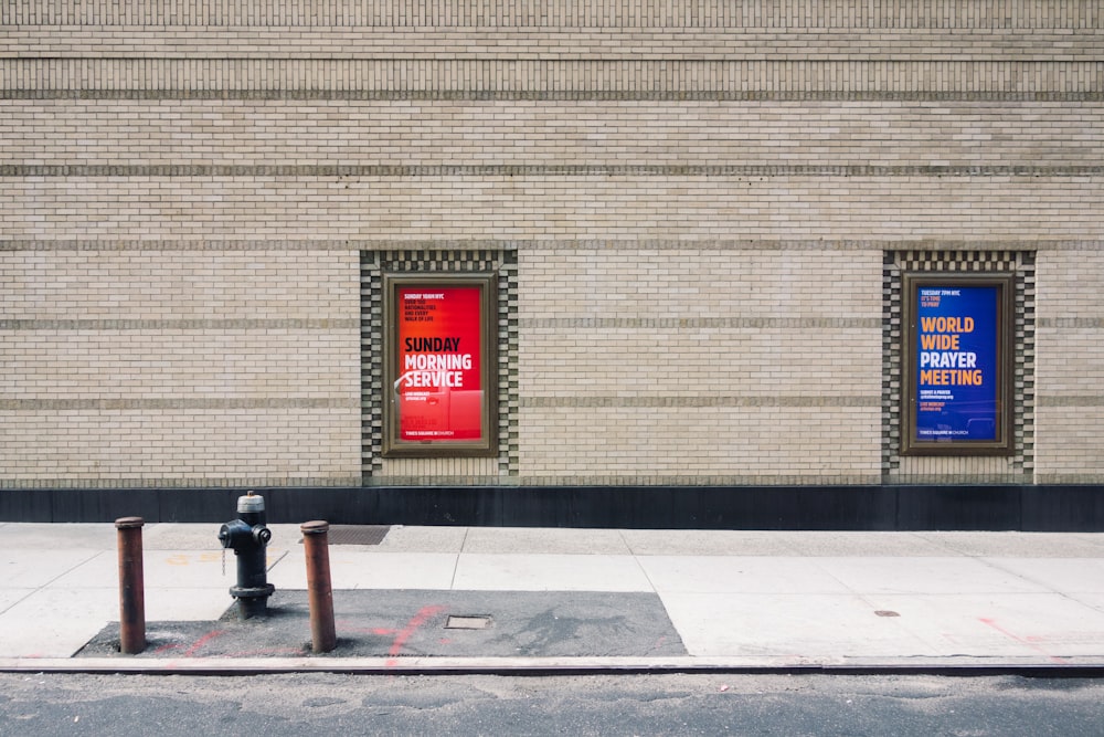 two assorted wall signage on brown building