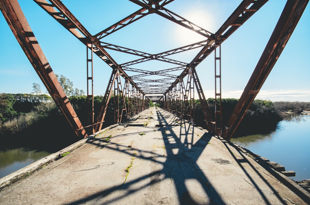 brown bridge under blue and white cloudy sky during daytime