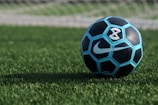 blue and black Nike soccer ball