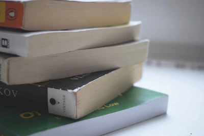 A colorful stack of pre-owned books with worn spines inviting a new home.