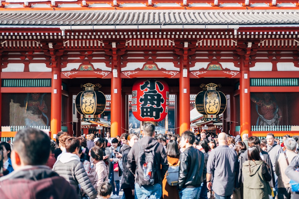 group of people standing near Chinese temple during daytime