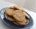 Close-up of a plate filled with vintage-style homemade cookies on a rustic wooden table.