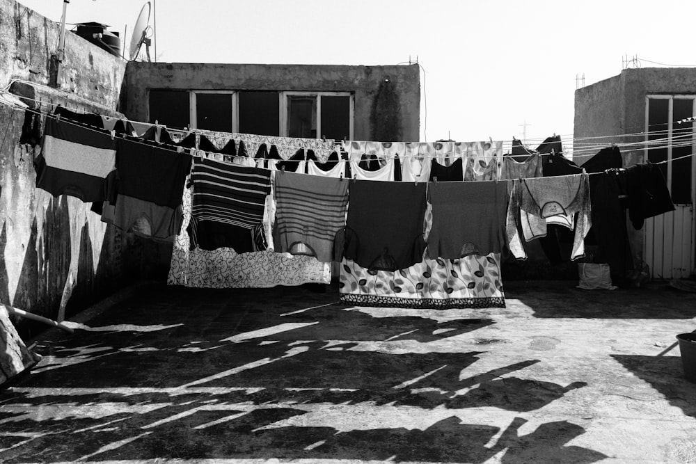 grayscale photography of hanged clothes