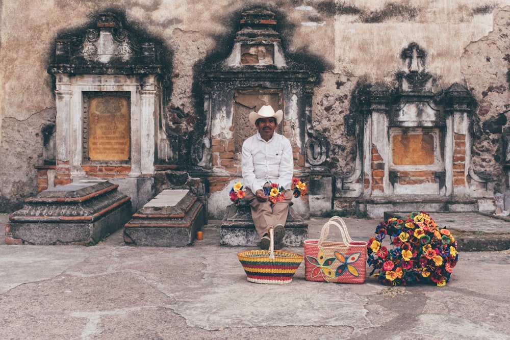 man sitting on tombstone