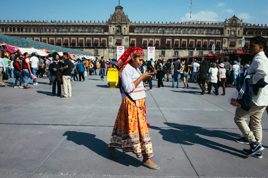 woman wearing floral dress standing near concrete building in Mexico City Mexico